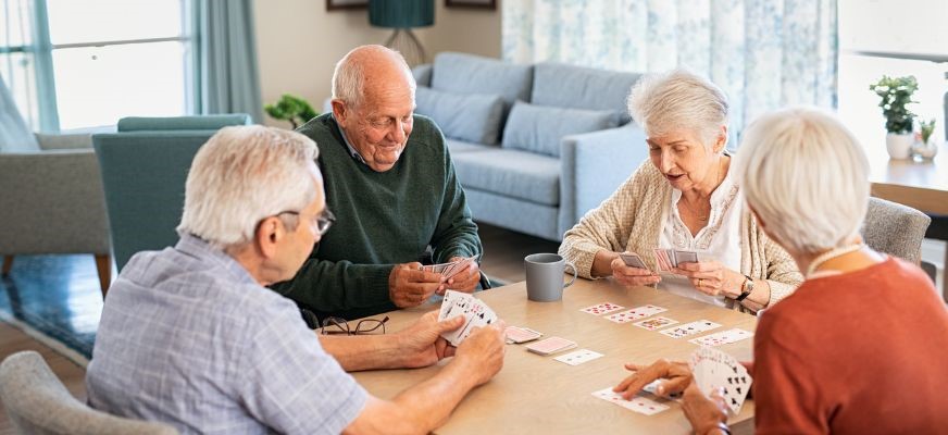 seniors playing cards at a table