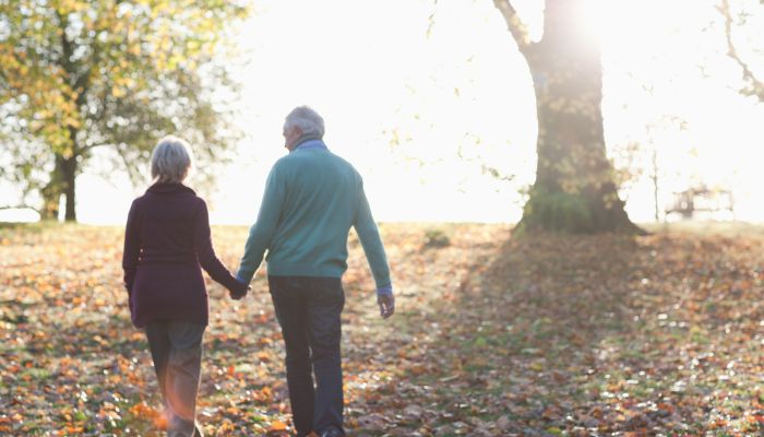 elderly couple walking outdoors