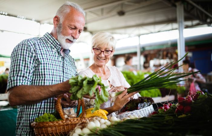 older couple shopping for fresh vegetables