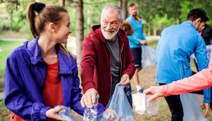 senior man volunteering to clean up a park