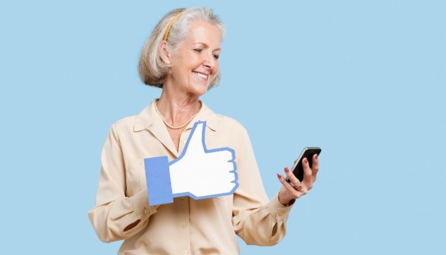 woman standing with a "like" thumbs up sign on her hand