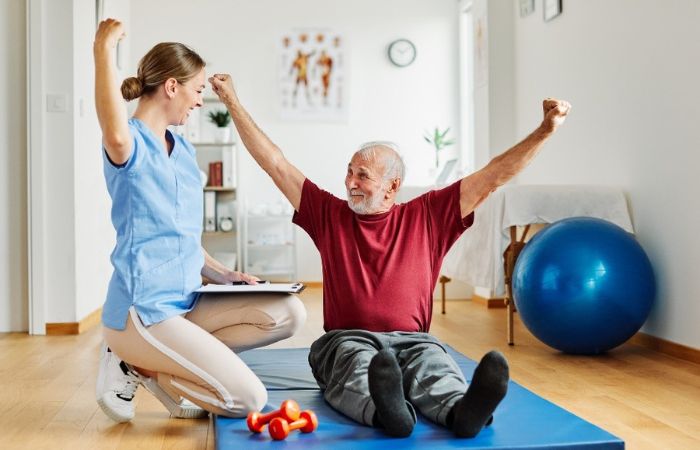 female PT working with a senior male 